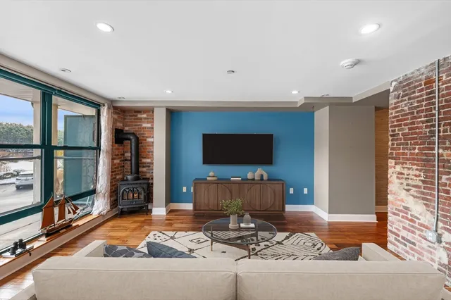 a view of a room with wooden floor and floor to ceiling window