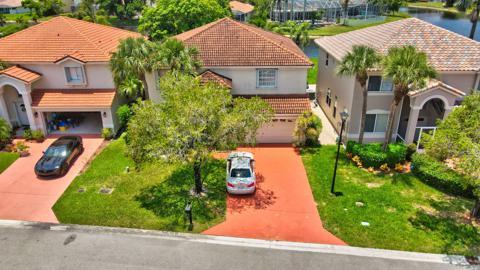 an aerial view of a house with garden space and street view