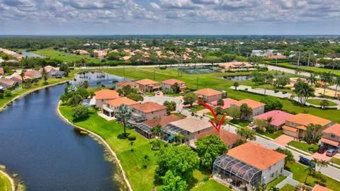 an aerial view of a houses with a lake
