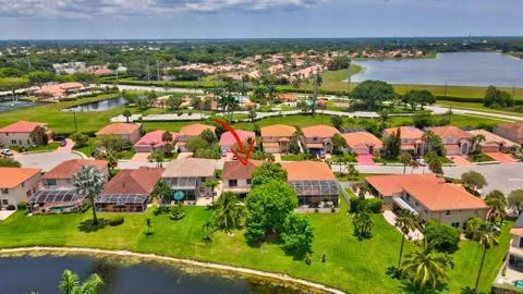 an aerial view of residential houses with outdoor space and swimming pool