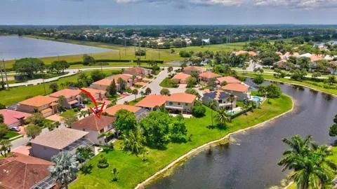 an aerial view of a city with lots of residential buildings and mountain view in back