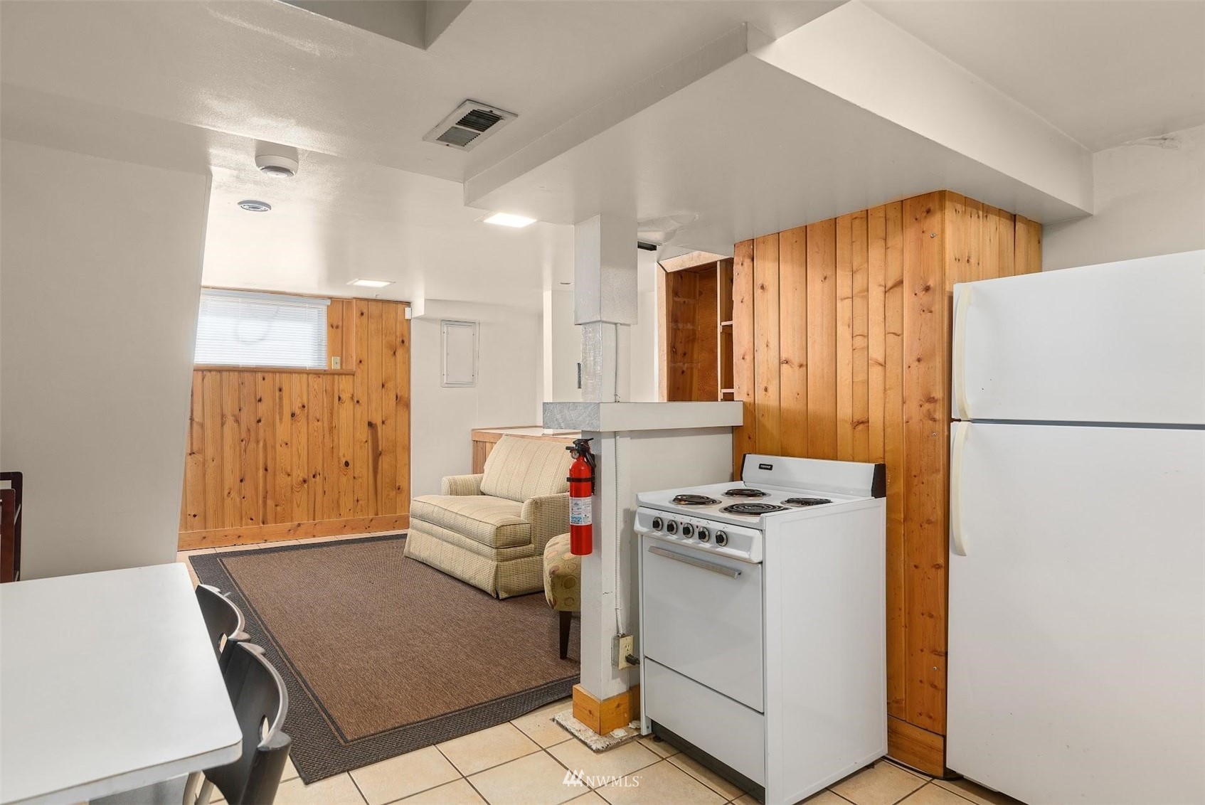 5416 20th Avenue Northeast Seattle, WA 98105 - Photo 15 of 21 a kitchen with a stove a refrigerator and a table