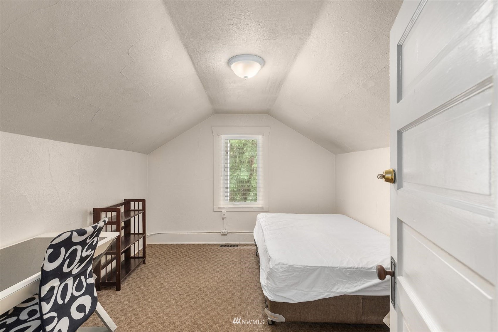 5416 20th Avenue Northeast Seattle, WA 98105 - Photo 16 of 21 a bedroom with a bed and a window