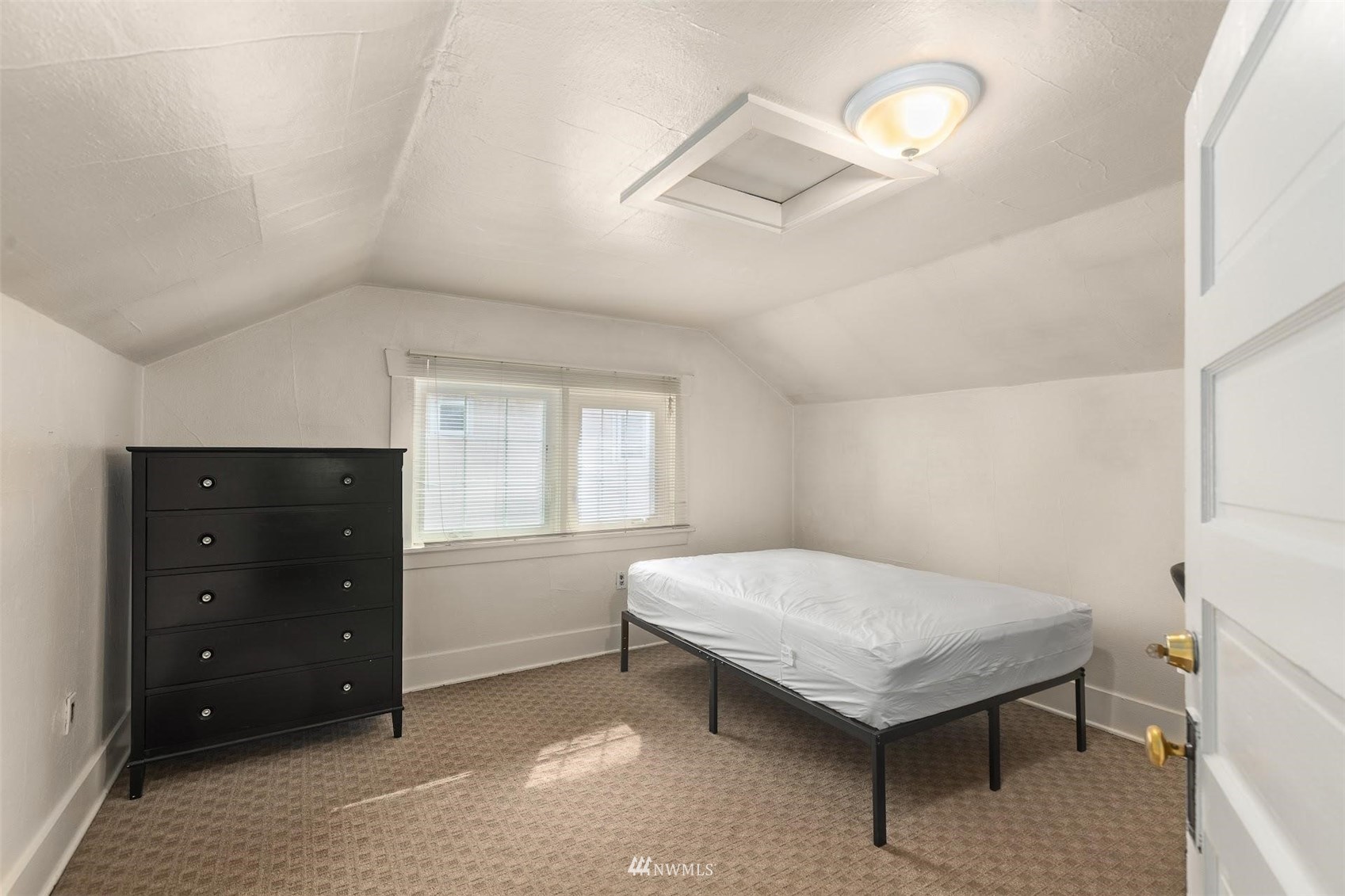5416 20th Avenue Northeast Seattle, WA 98105 - Photo 17 of 21 a bedroom with a bed and a dresser