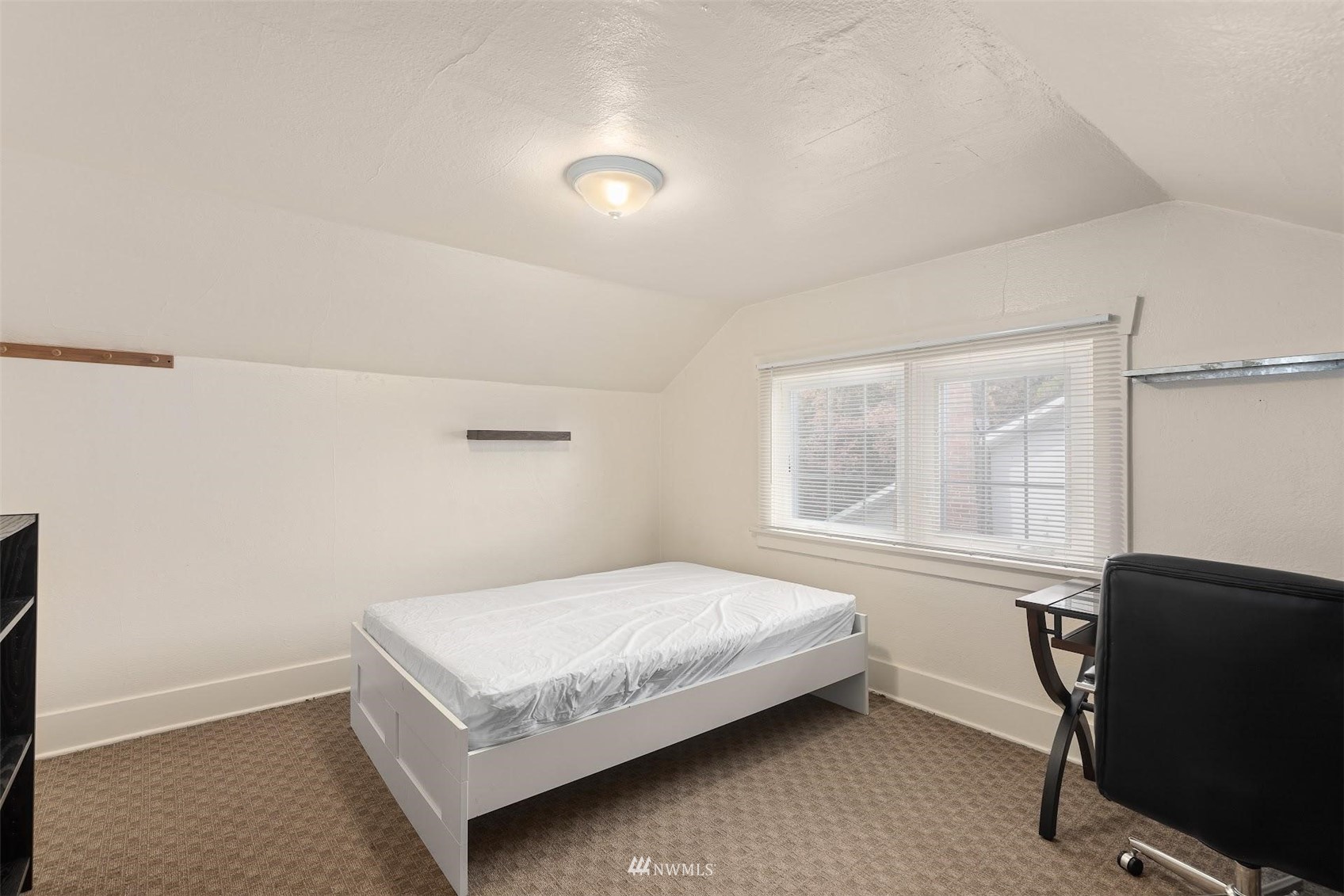 5416 20th Avenue Northeast Seattle, WA 98105 - Photo 18 of 21 a bedroom with a bed and window