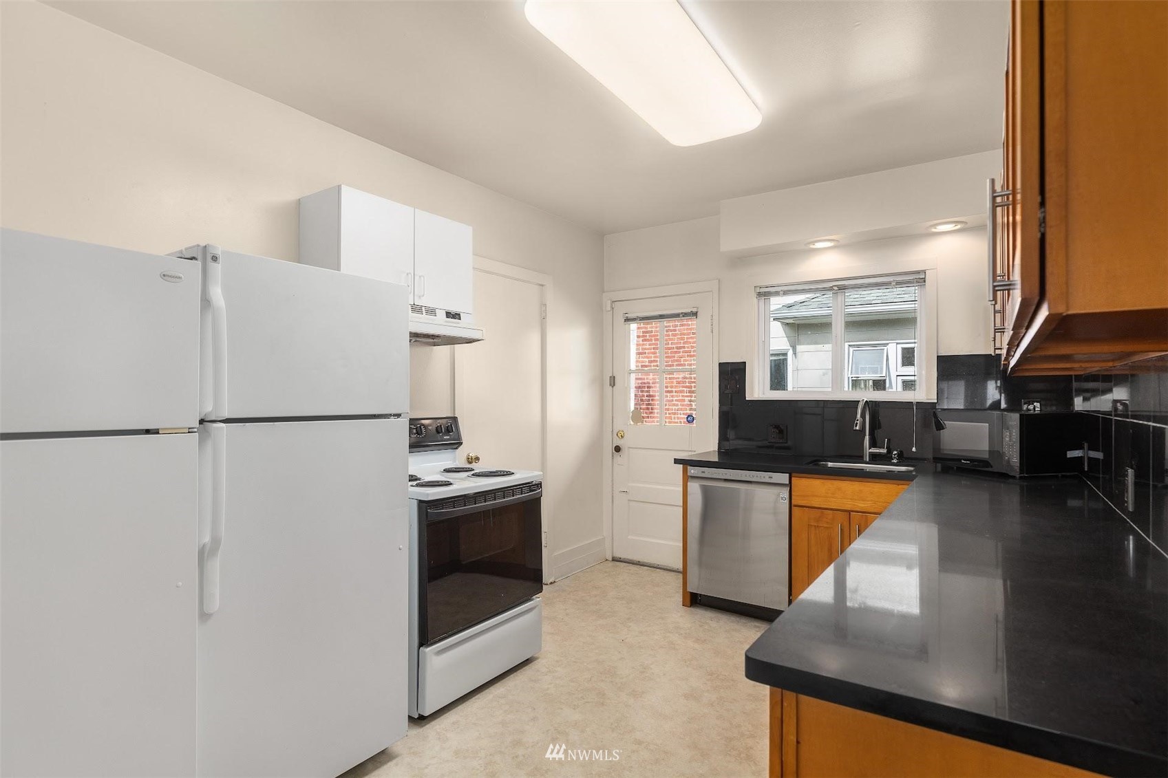 5416 20th Avenue Northeast Seattle, WA 98105 - Photo 7 of 21 a kitchen with a refrigerator sink and stove top oven