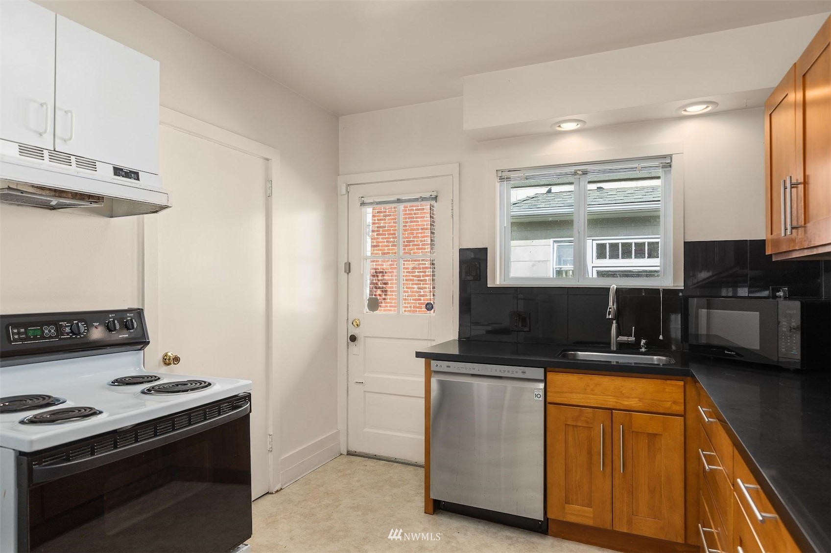 5416 20th Avenue Northeast Seattle, WA 98105 - Photo 8 of 21 a kitchen with stainless steel appliances a stove a sink and a microwave