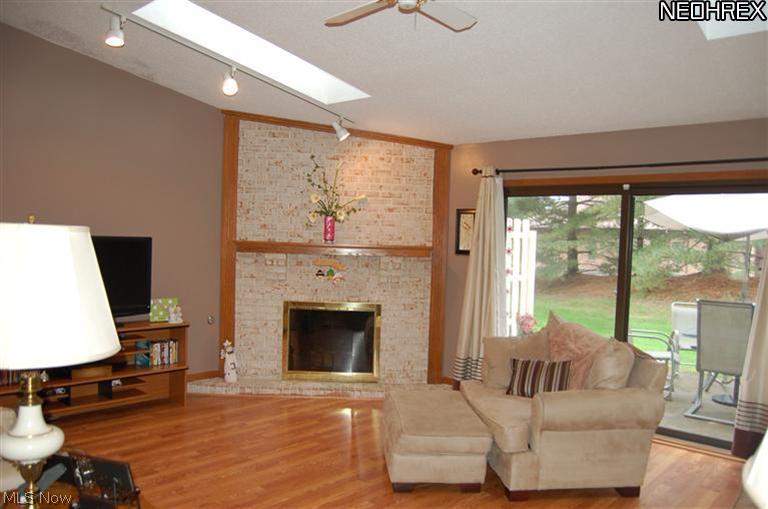 1260 Boardman-Canfield Road, Unit J27 Youngstown, OH 44512 - Photo 5 of 9 Great room with brick fireplace & new flooring