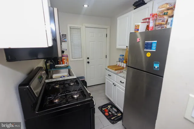 a kitchen with a refrigerator and a stove