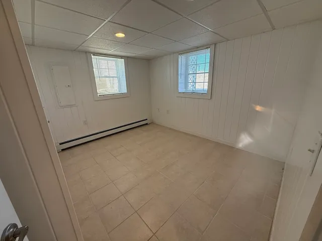 an empty room with windows and closet
