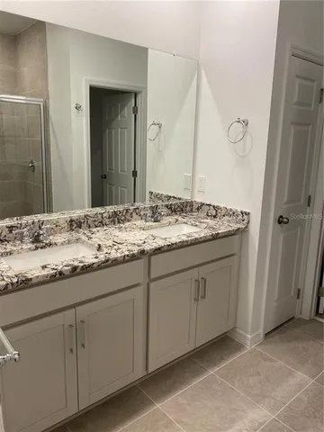 a bathroom with a glass door shower