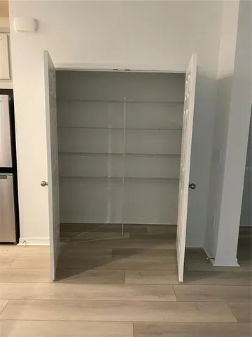 an empty room with a exposed radiator and a window