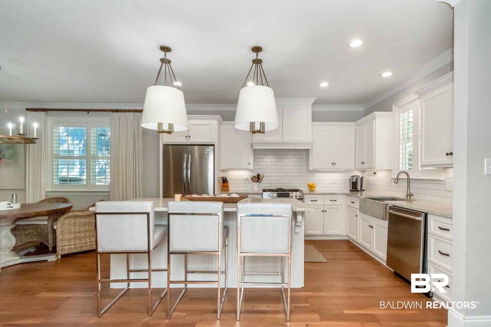 4404 Stein Street Mobile, AL 36608 - Photo 15 of 50 Kitchen with pendant lighting, a kitchen island, white cabinets, stainless steel appliances, and a kitchen bar
