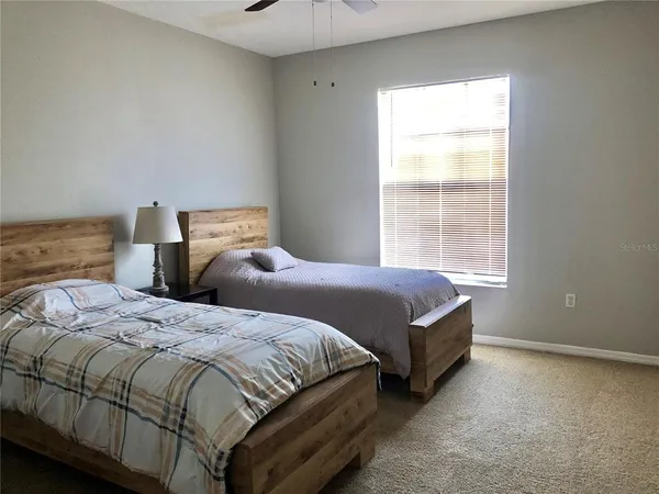 a bedroom with a bed and a window