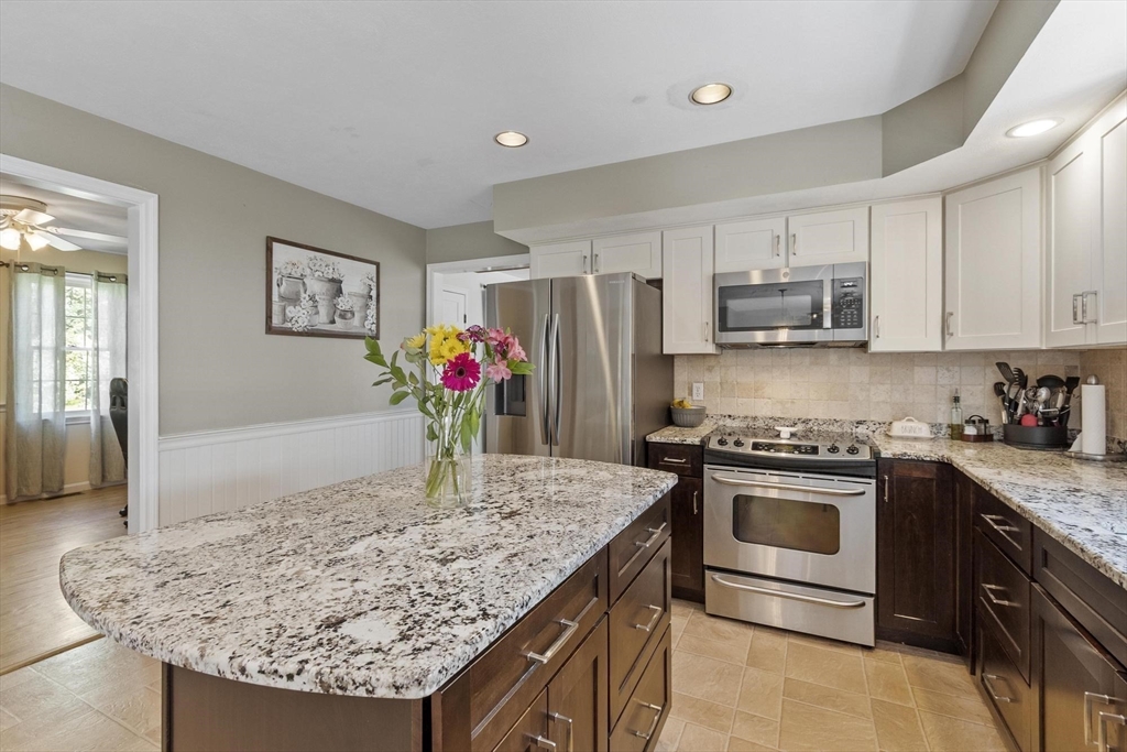 4 Ridge Road Pepperell, MA 01463 - Photo 11 of 42 a kitchen with stainless steel appliances granite countertop a sink stove and refrigerator