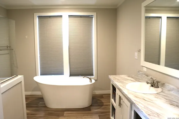 a bathroom with a granite countertop shower mirror and a sink