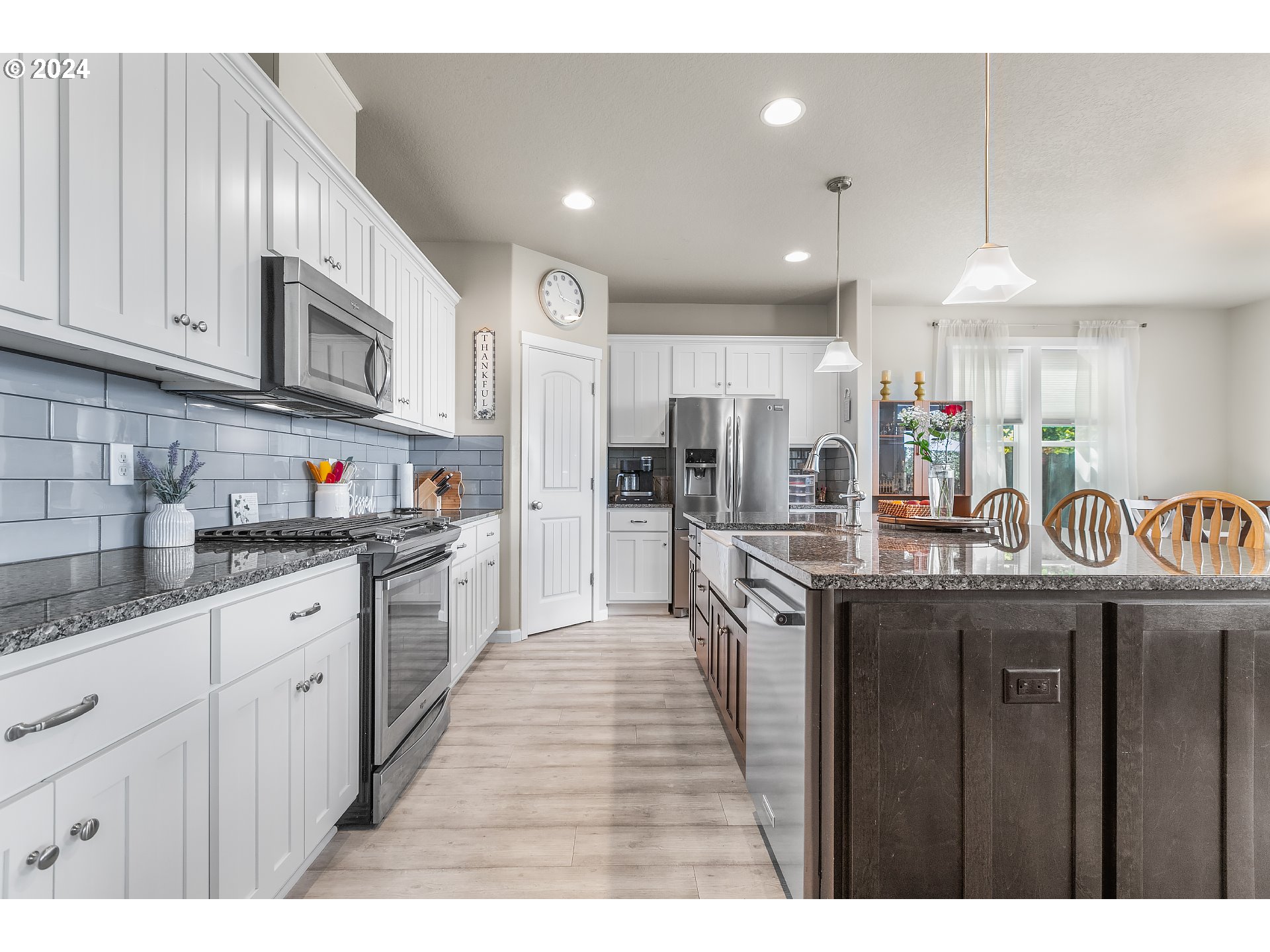 4837 North 6th Street Ridgefield, WA 98642 - Photo 5 of 43 a kitchen with stainless steel appliances granite countertop wooden cabinets a sink dishwasher a stove and a refrigerator