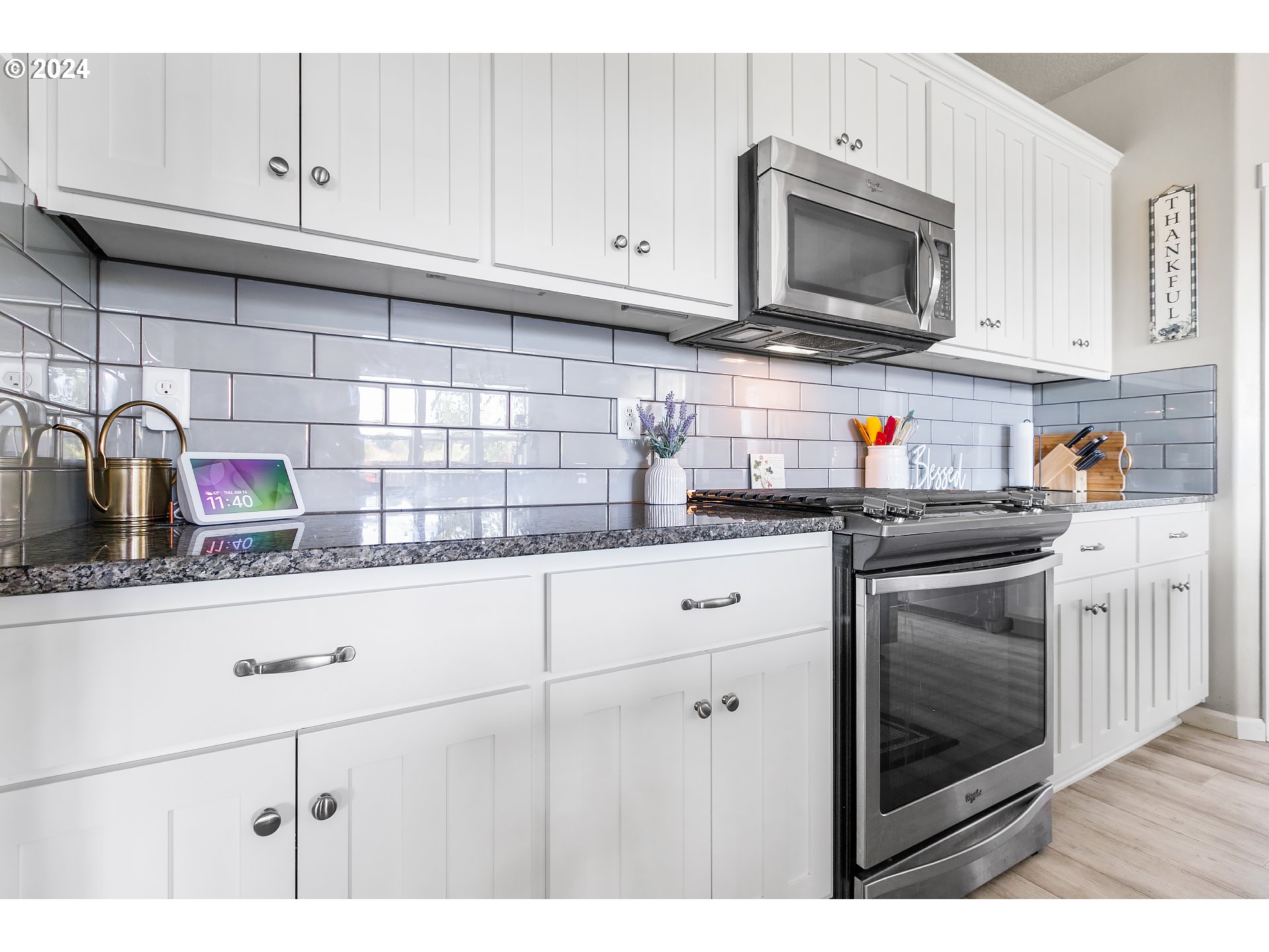 4837 North 6th Street Ridgefield, WA 98642 - Photo 7 of 43 a kitchen with stainless steel appliances granite countertop a sink stove and microwave