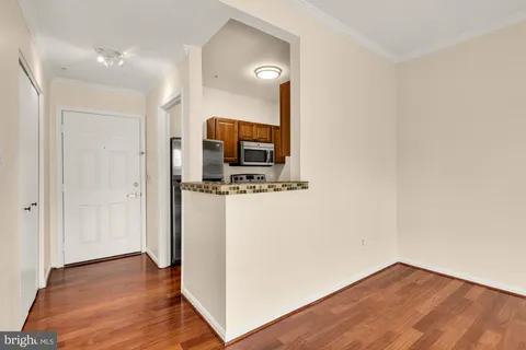 a view of a kitchen from the hallway