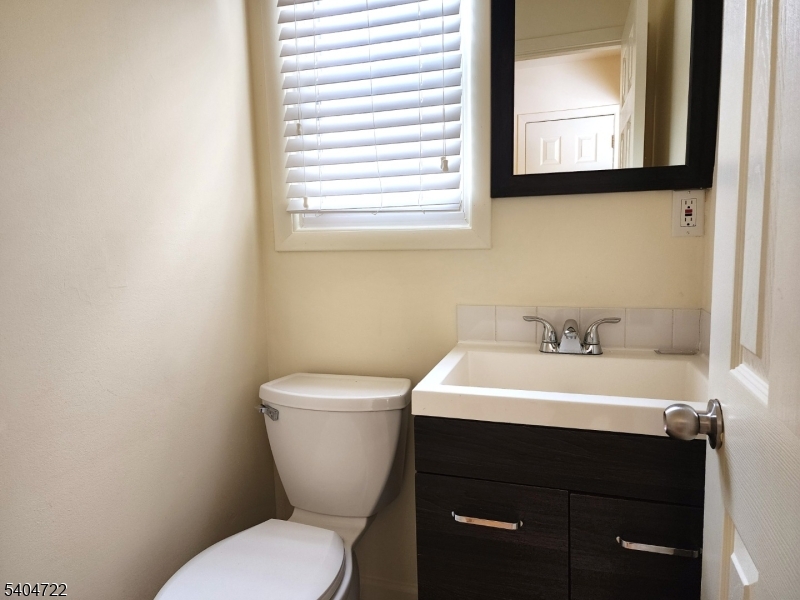 19 Grove Street, Unit B Wanaque, NJ 07465 - Photo 13 of 24 a bathroom with a toilet sink and mirror