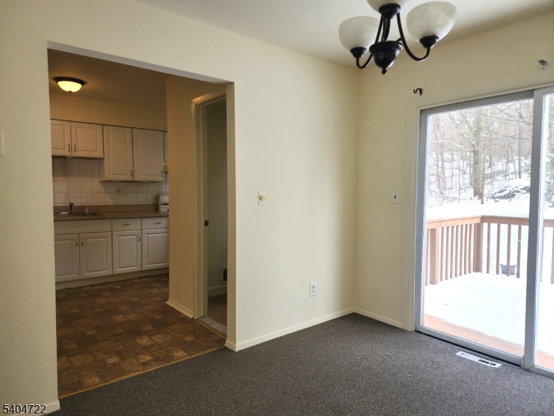 19 Grove Street, Unit B Wanaque, NJ 07465 - Photo 7 of 24 a view of a kitchen with a sink and cabinet area