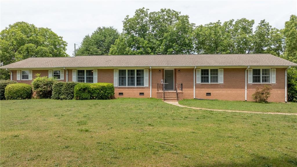570 Wildcat Bridge Road Royston, GA 30662 - Photo 2 of 29 a front view of a house with a yard and trees