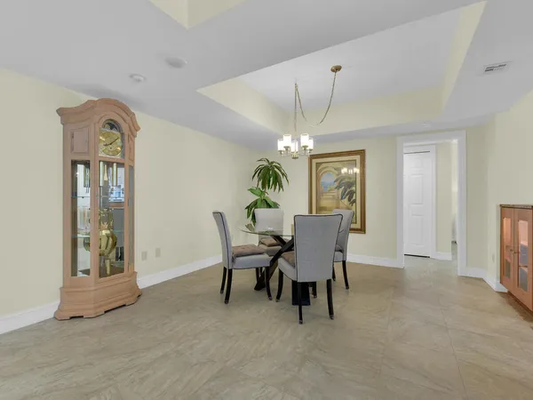 a view of a dining room with furniture and chandelier