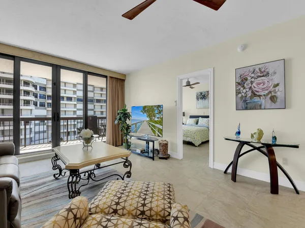 a living room with furniture a window and a flat screen tv