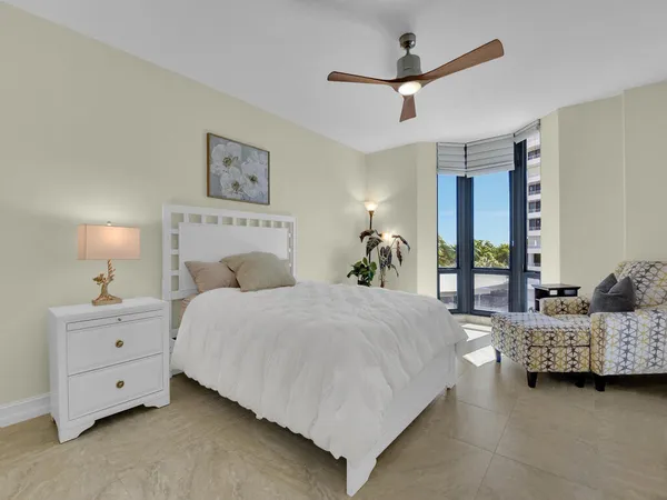 a bedroom with bed and a chandelier