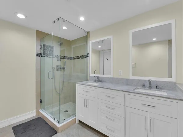 a bathroom with a shower sink double and mirror