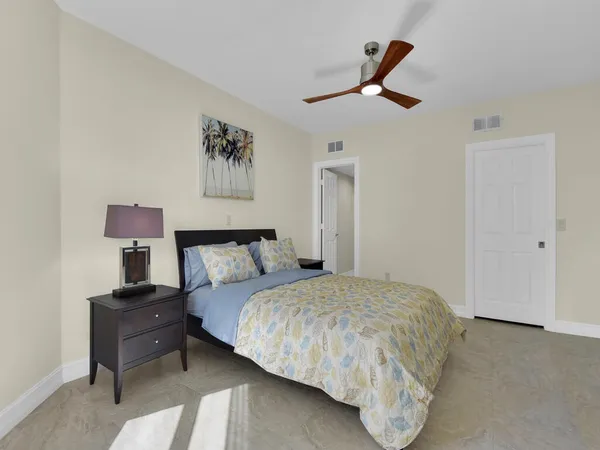 a bedroom with a bed and painting on the wall