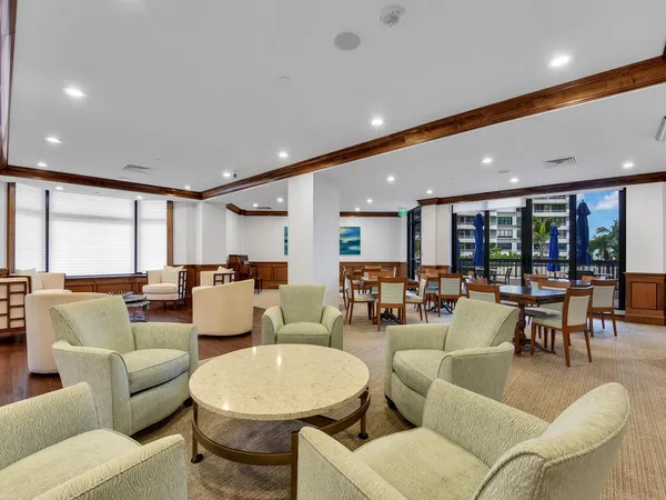 a living room with furniture and large windows