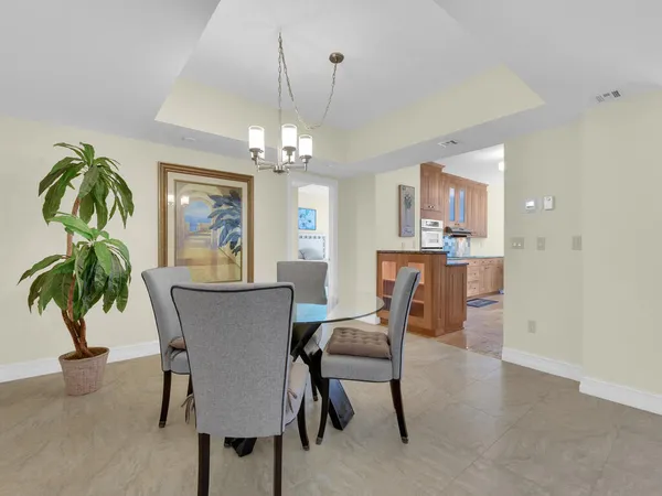 a view of a dining room with furniture and chandelier