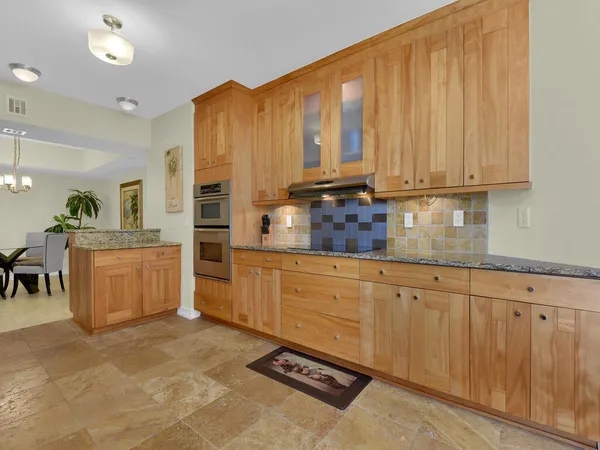 a kitchen with stainless steel appliances a refrigerator sink and cabinets