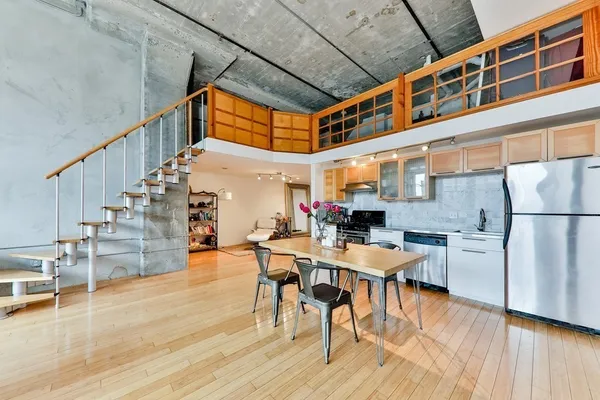 a dining room with furniture entryway and wooden floor