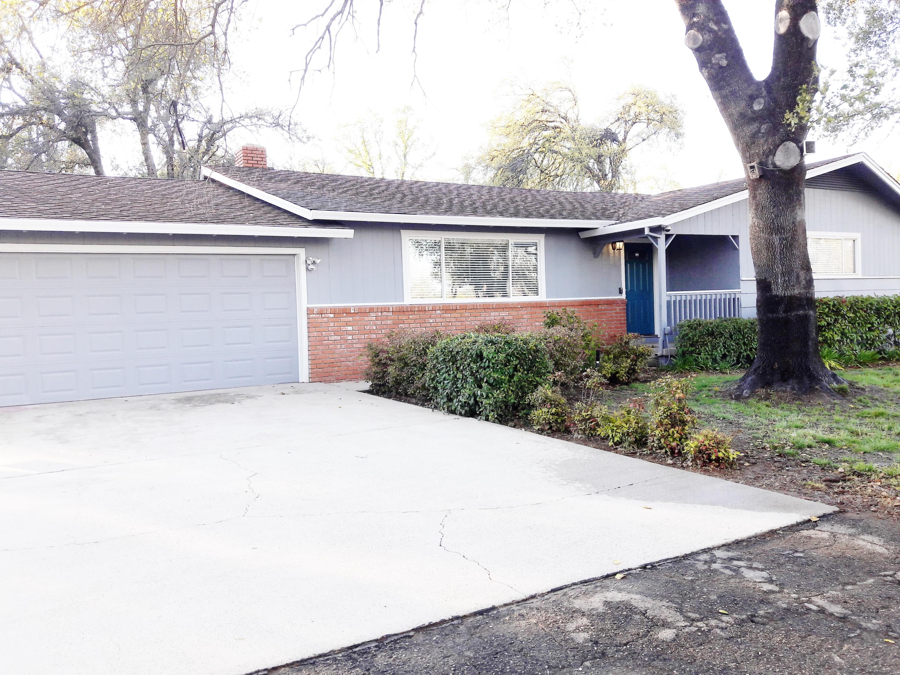 1610 Canyon Road Redding, CA 96001 - Photo 1 of 41 a front view of a house with a yard and garage