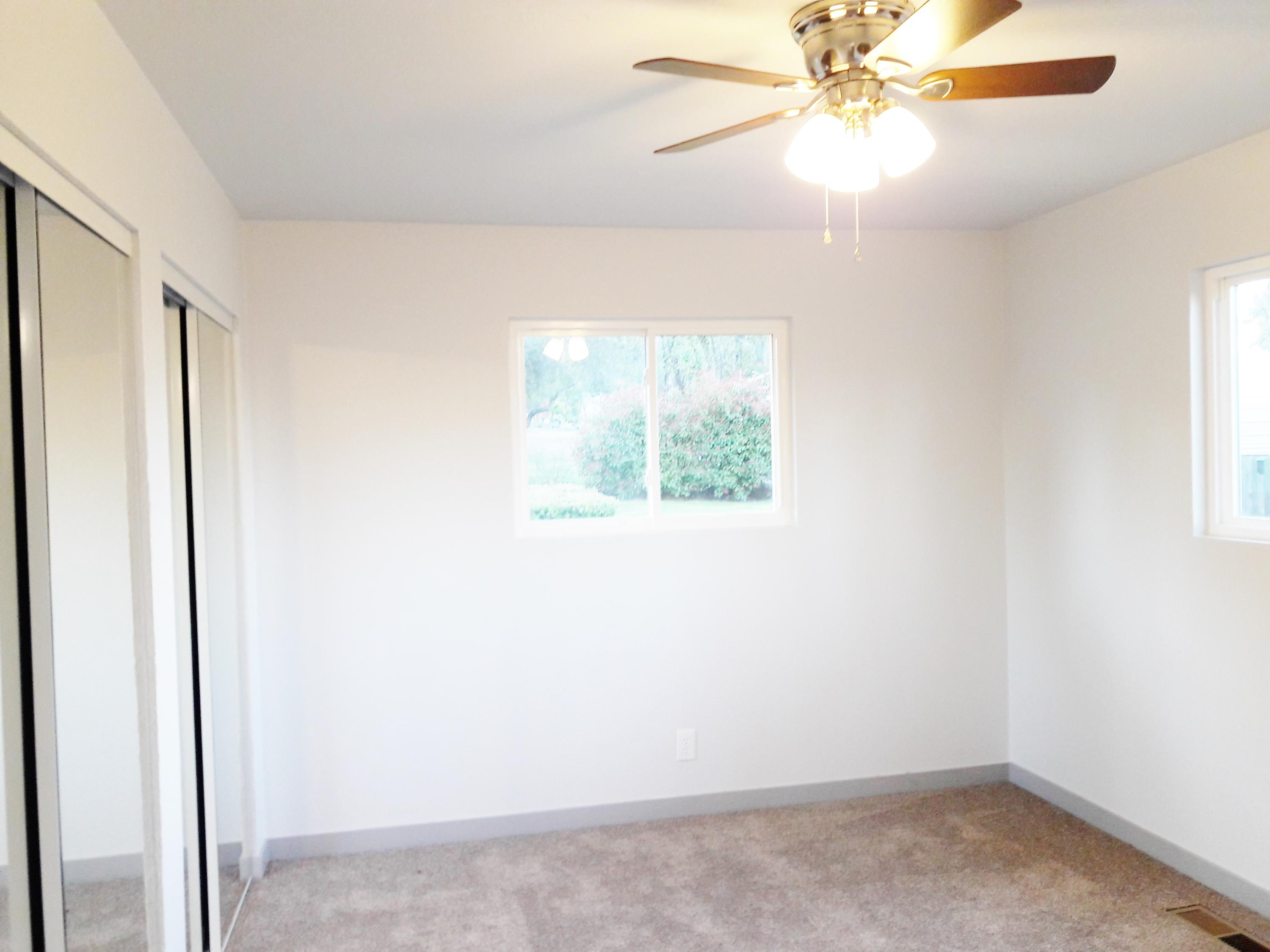 1610 Canyon Road Redding, CA 96001 - Photo 20 of 41 an empty room with a window and a fan
