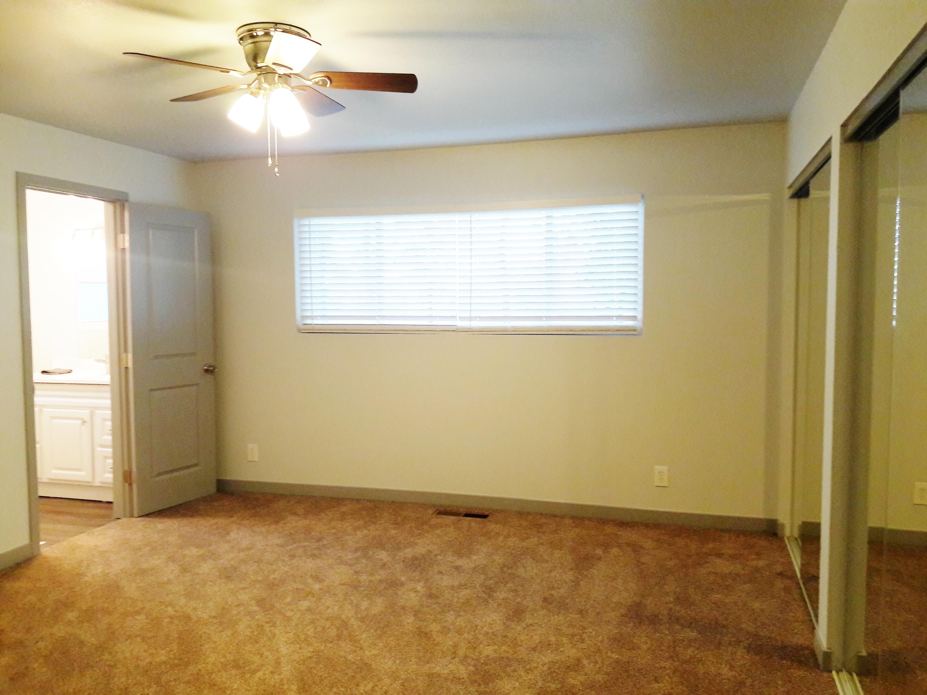 1610 Canyon Road Redding, CA 96001 - Photo 27 of 41 a view of an empty room with chandelier fan and a window