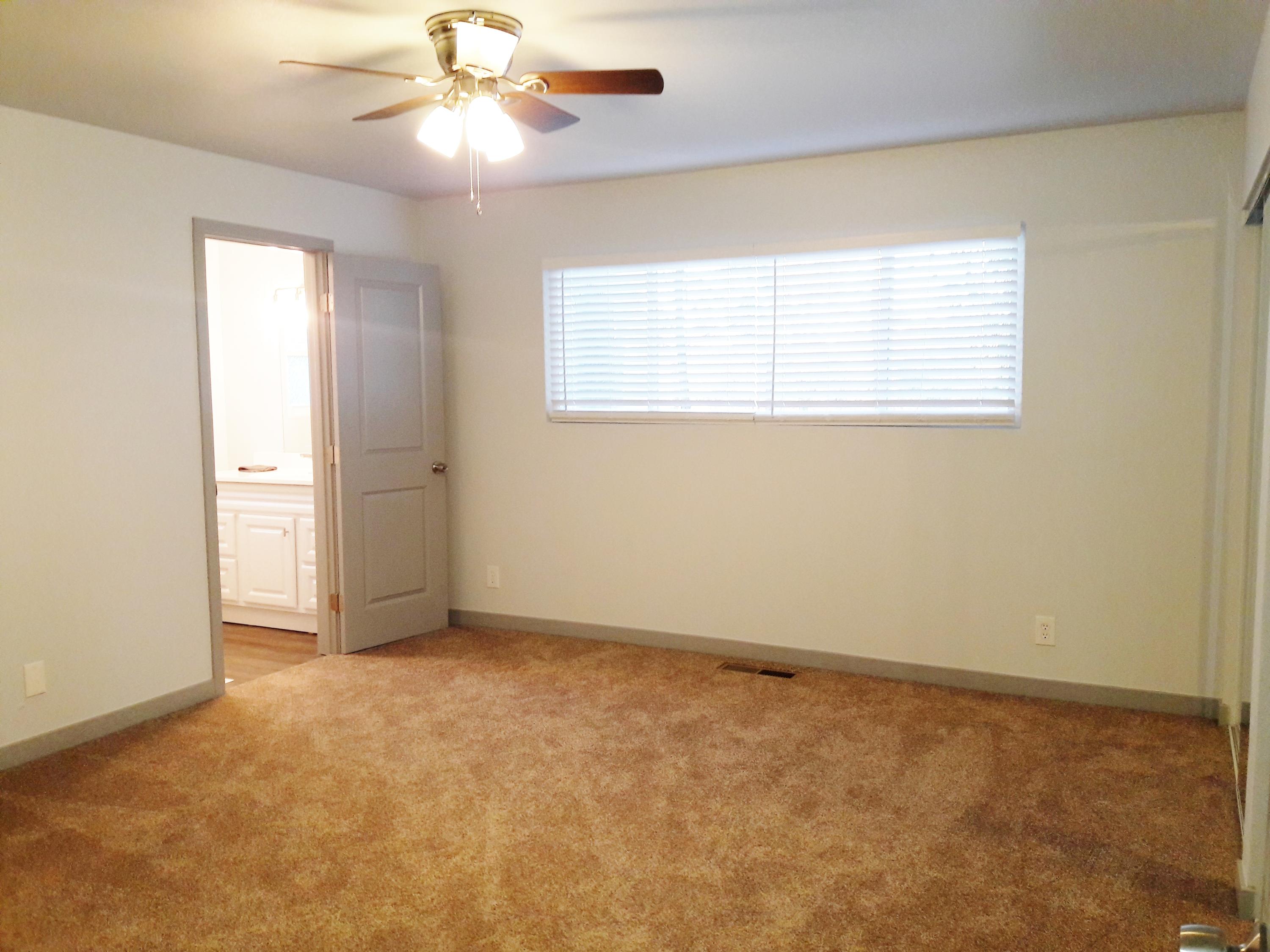 1610 Canyon Road Redding, CA 96001 - Photo 28 of 41 an empty room with a window and a fan