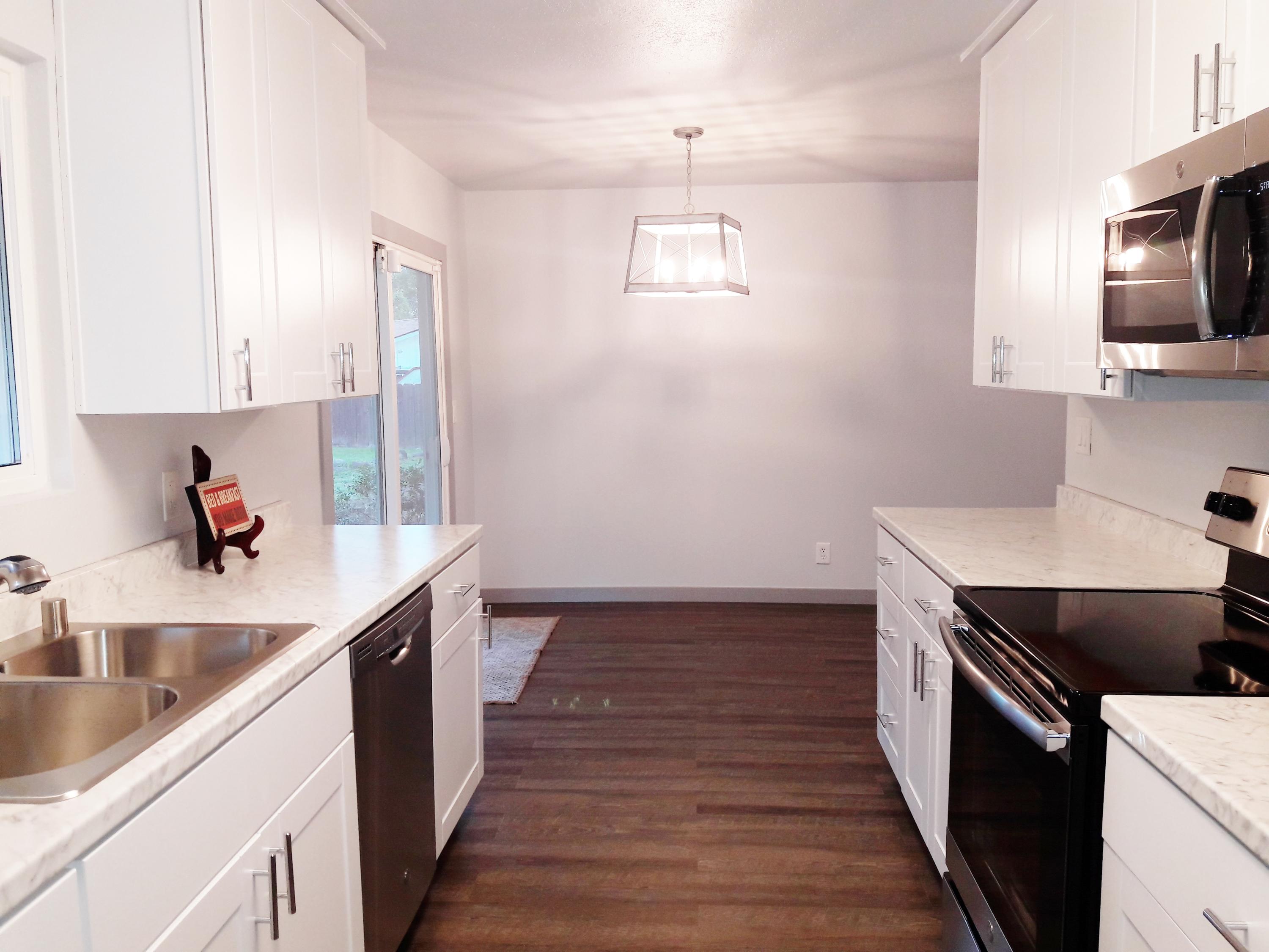 1610 Canyon Road Redding, CA 96001 - Photo 10 of 41 a kitchen with a sink and wooden floor