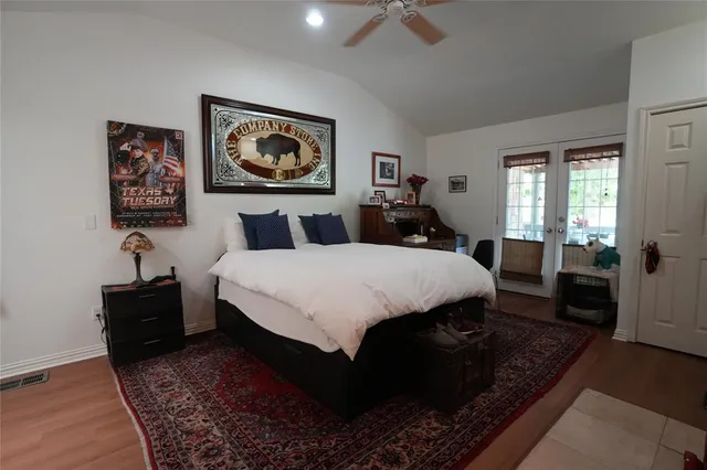 a bed room with a bed and a painting on the wall