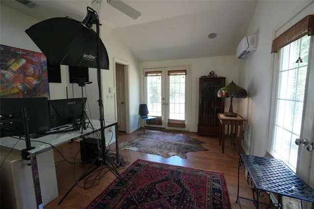 a living room with furniture a flat screen tv and a window