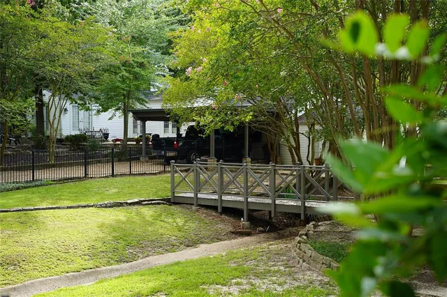 a view of backyard with swimming pool and sitting area