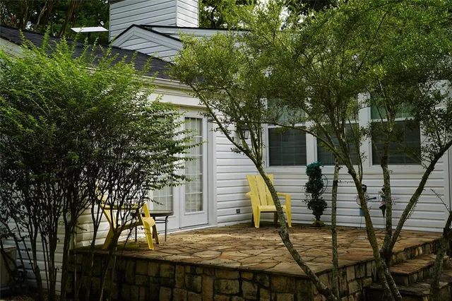 a view of house with backyard and seating area