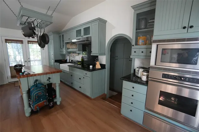 a kitchen with stainless steel appliances a stove a sink a stove and cabinets