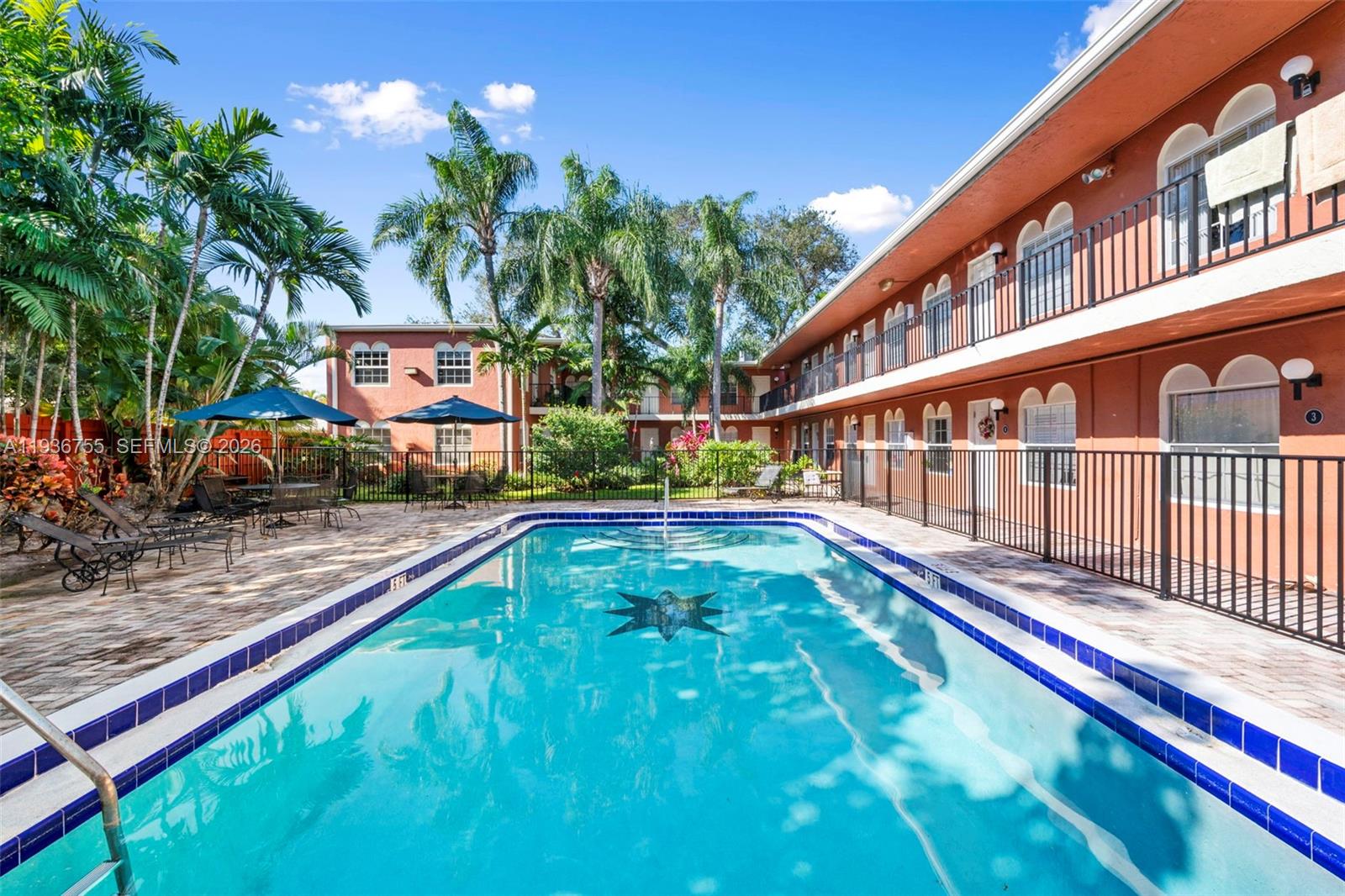 a view of swimming pool with sitting area