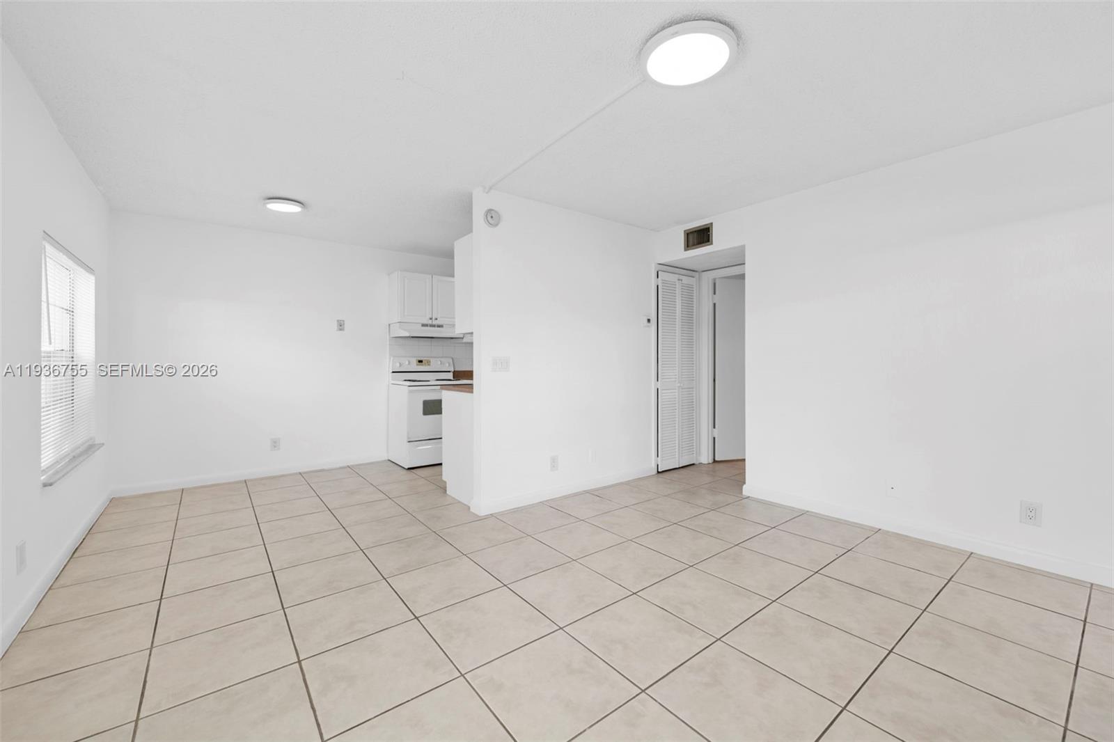 1405 Miami Road, Unit 10 Fort Lauderdale, FL 33316 - Photo 11 of 14 an empty room with white walls and tiles