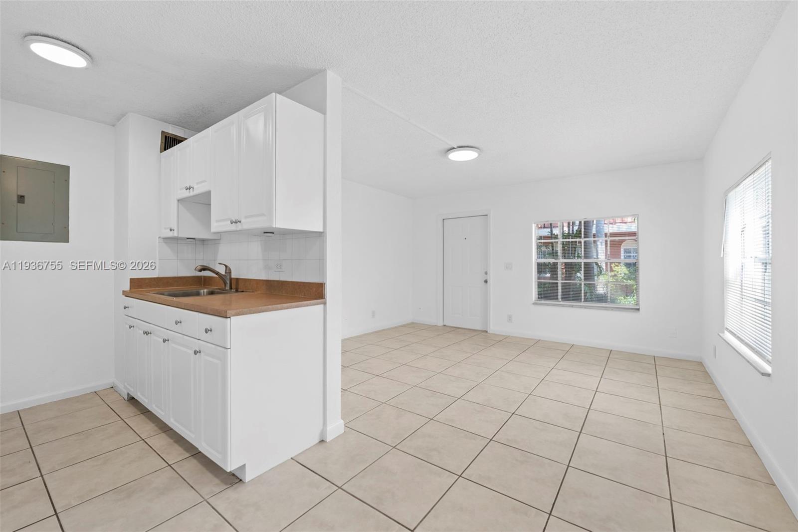 1405 Miami Road, Unit 10 Fort Lauderdale, FL 33316 - Photo 13 of 14 a view of kitchen with granite countertop cabinets and sink