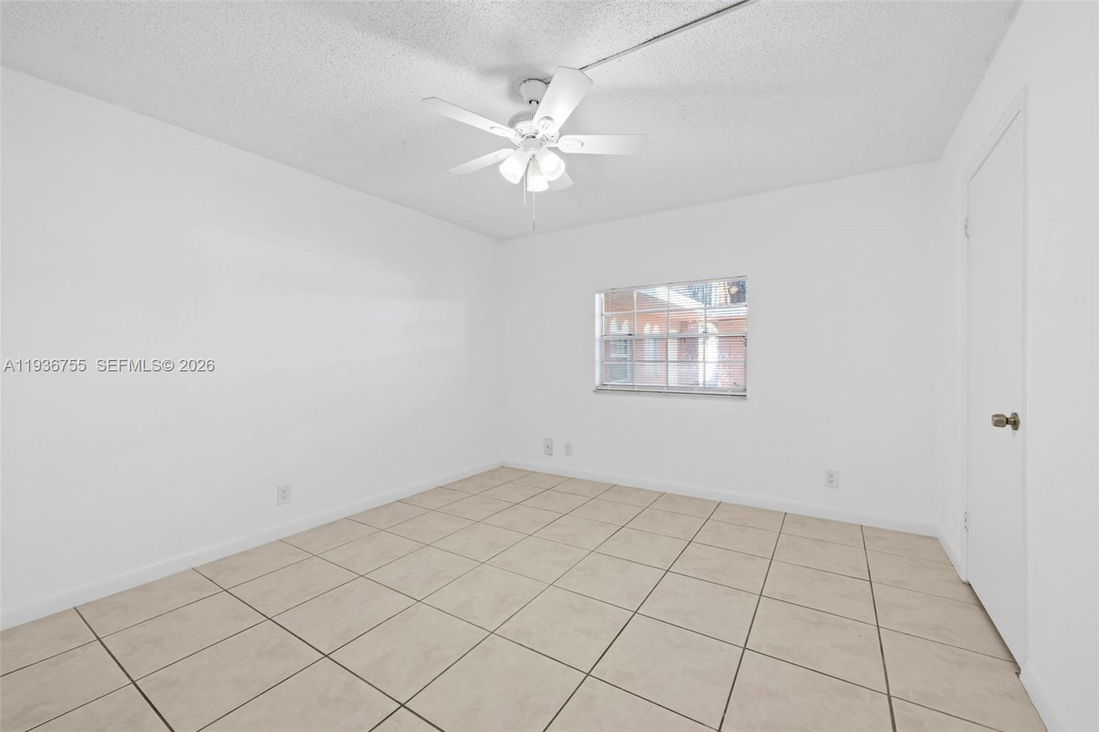 1405 Miami Road, Unit 10 Fort Lauderdale, FL 33316 - Photo 14 of 14 an empty room with white walls and ceiling fan