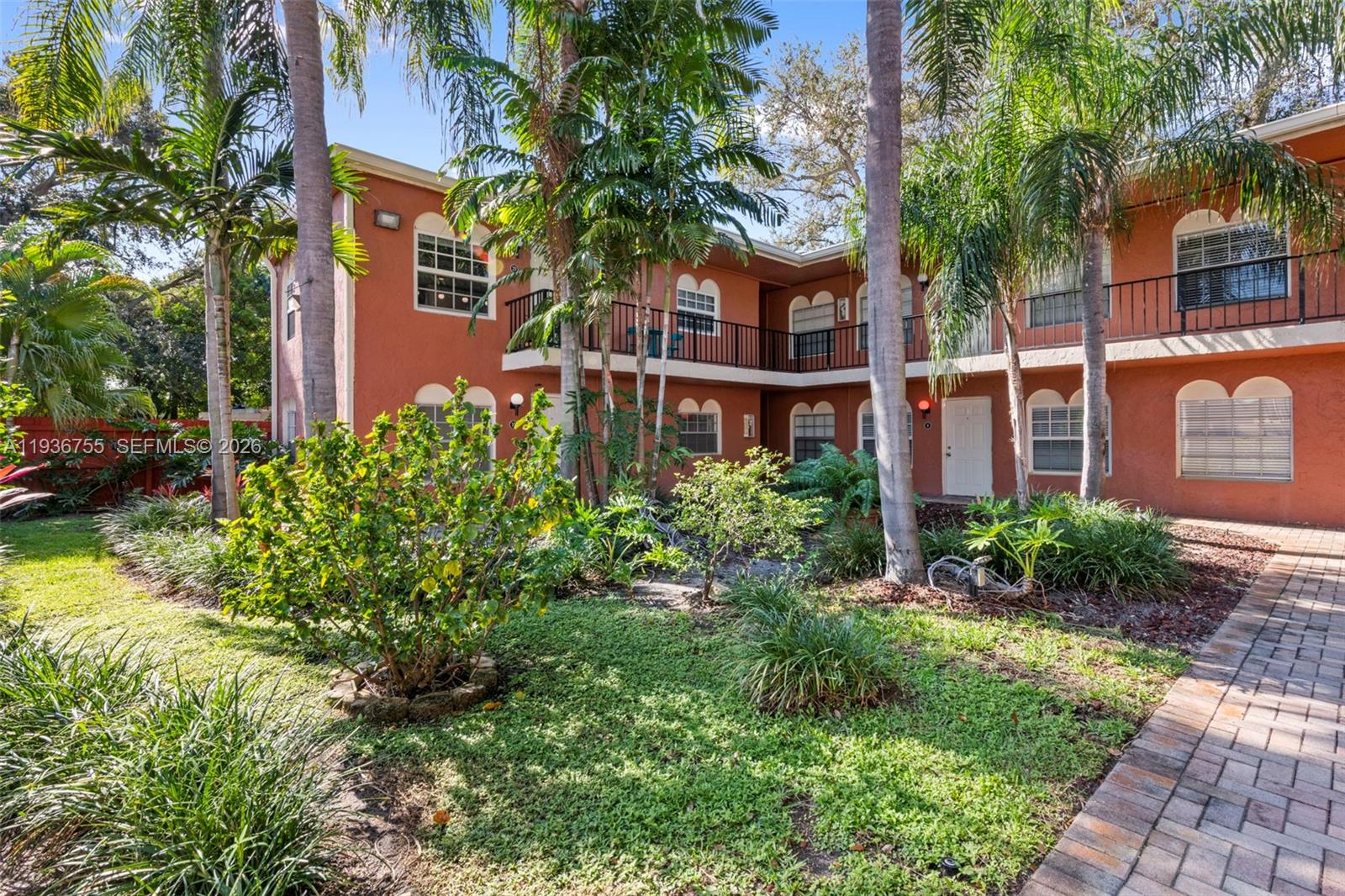 1405 Miami Road, Unit 10 Fort Lauderdale, FL 33316 - Photo 2 of 14 a view of a brick building next to a yard